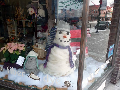 roving snowman in the yarn shop window