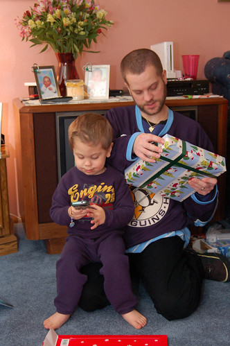 Christmas Eve:  Noah placing an important call while Mike opens his present.