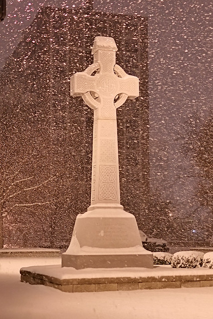 Saint John the Apostle and Evangelist Catholic Church, in Saint Louis, Missouri, USA - Celtic Cross, at night in the snow