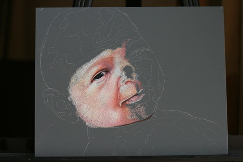 In progress colored pencil drawing of a newborn.