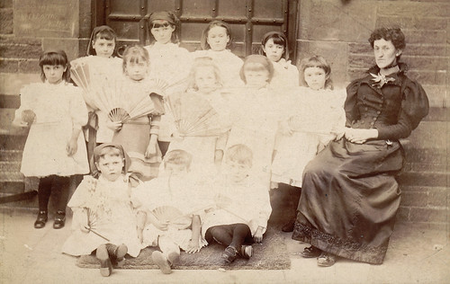 Schoolgirls with fans. Bingley, Yorkshire.