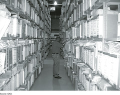 Figure 7: GAO Analyst Examining Files at FEMA’s Engineering Library by U.S. GAO