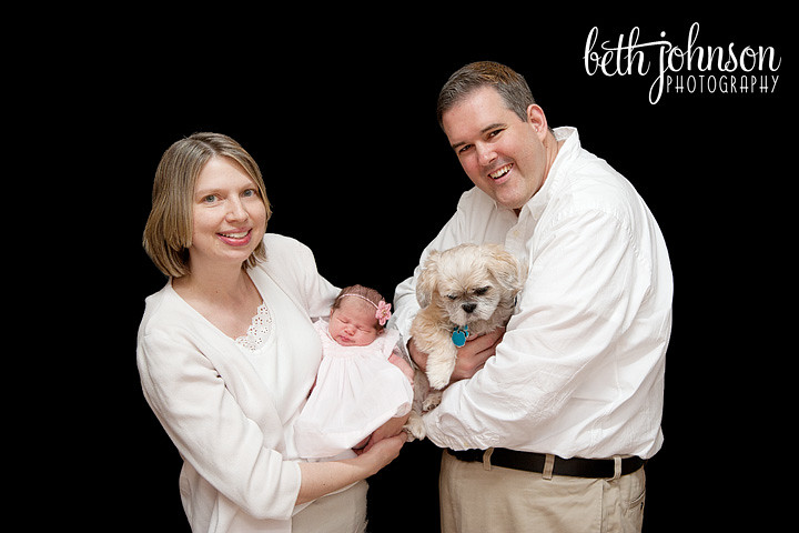 newborn girl with family and dog