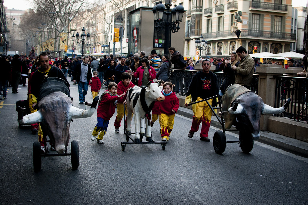 Kids running with a papier-maché cow
