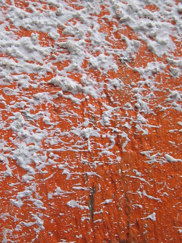 Gray Paint Splatters on Orange Surface