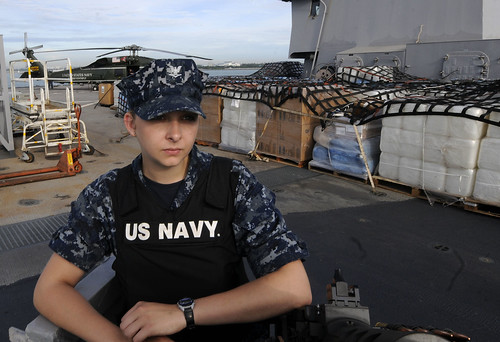 Sailor stands watch as USS Blue Ridge departs to support earthquake relief efforts.