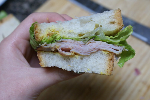 ciabatta with ham, lettuce, and mustard.