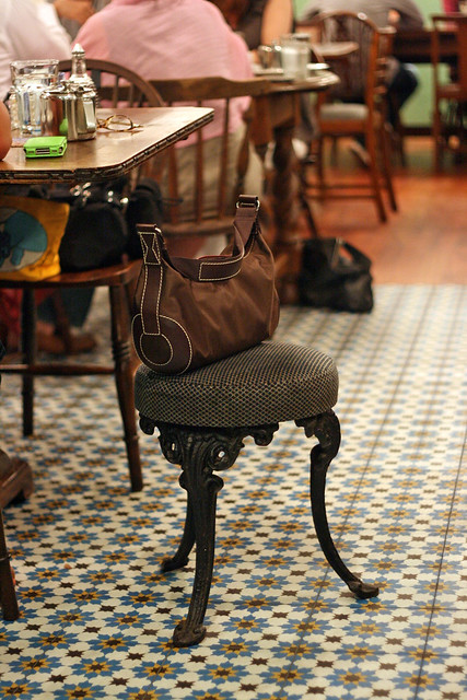 Eclectic furniture, handbag stools, and vintage floral tiles