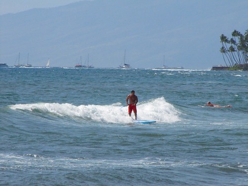 burly surfer in red trunks