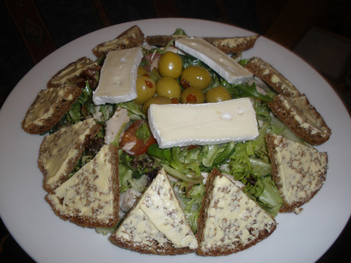Chicken salad with rye bread, brie and olives
