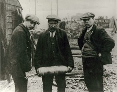 Three men with shell