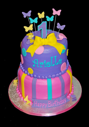 2 tier purple turquoise yellow and pink cake for a 1st birthday Abby Cadabby