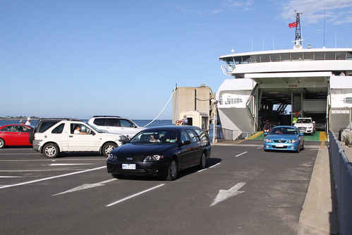 Cars drive off the ferry at Queenscliff, cars to the left waiting to drive on