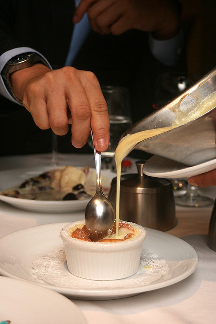 Grand Marnier Souffle - the server pours vanilla cream infused with bittersweet orange liquer