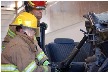 Firefighters practice with gear that helps extract auto crash victims at a new USDA funded fire station in Idaho