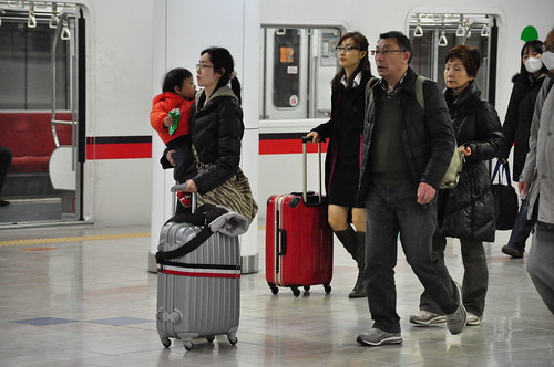 Japan Earthquake: kids leaving Tokyo from Haneda airport