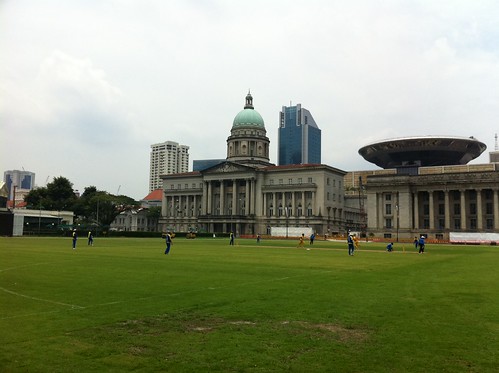 Cricket on the Padang. Supreme Court in  background by opticmerv
