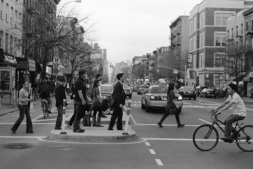 People at a busy East Village crosswalk