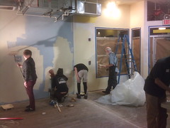 Volunteers paint the shop