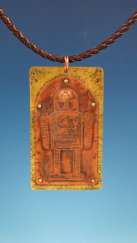 etched spaceman pendant with simulated opal headlamp
