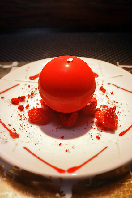 The Sphere coated with ivory chocolate and tangy raspberries