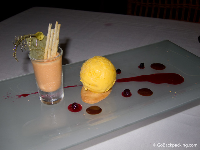Passion fruit ice cream, tangerine mousse, and Aguardiente-flavored cookie with a strawberry coulis and touch of chocolate sauce.