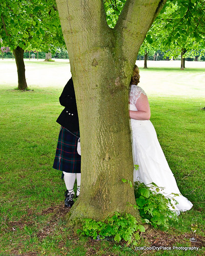 Chris and Laura snogging behind a tree