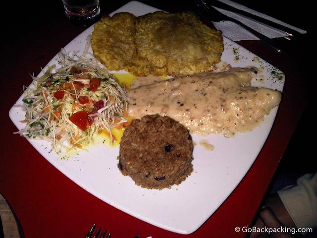 Fish, served with plantains, coconut rice, and salad.