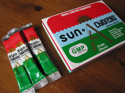 Sun Chlorella granules packets and box of tablet supplements