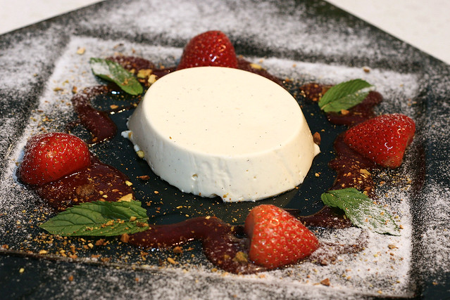 Traditional Panna Cotta with Vanilla, Pistachio Nuts and Strawberry Sauce
