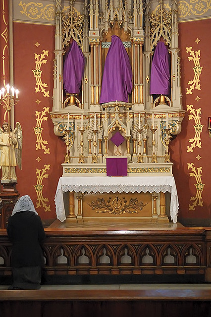 Saint Francis de Sales Oratory, in Saint Louis, Missouri, USA - shrouded images with worshipper