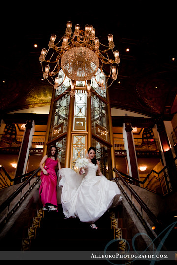 greek-wedding-spring-providence-ri- bride and her sister walk down grand staircase at providence biltmore hotel