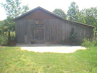 Garage sized shed with riding mower that stays