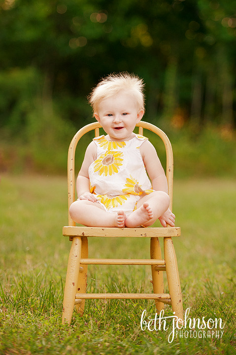 baby girl in antique yellow chair