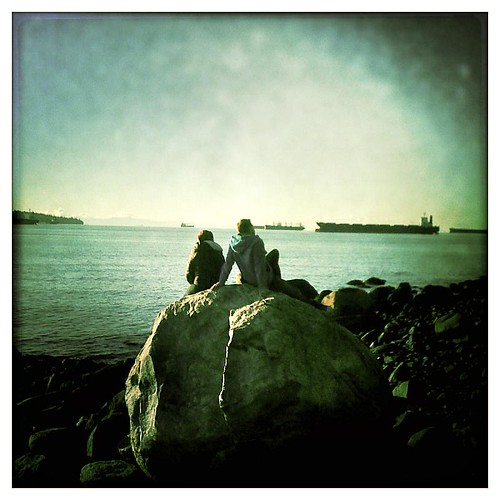 Couple on the rocks at 2nd Beach in Vancouver