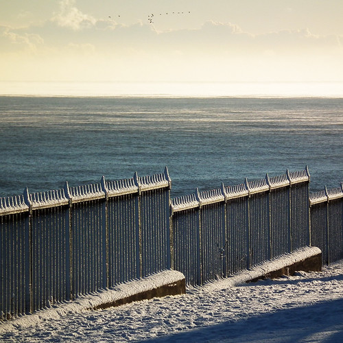 snowy seafront fence