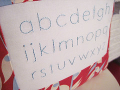 blue and red alphabet pillow