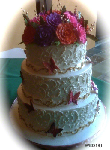  spring sugarpaste flowers with butterflies and gold accents wedding cake 