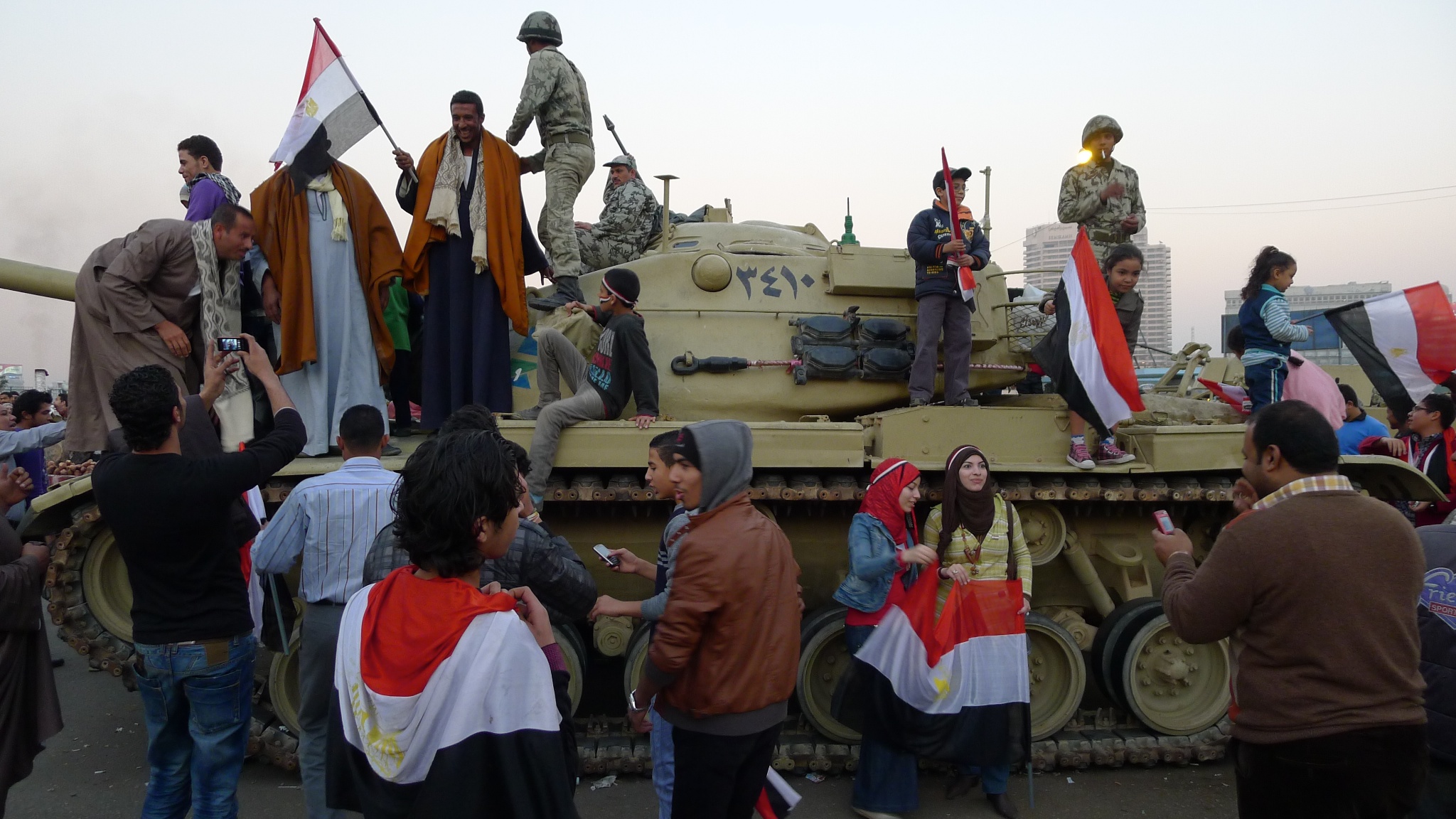 Photograph of protesters standing on a M-60 tank taken by Stefan Geens used under a creative commons license.