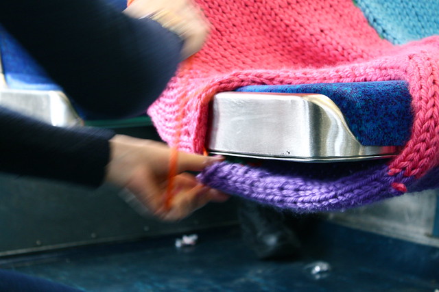 Ishkits puts the finishing touches on a SEPTA seat cozy.