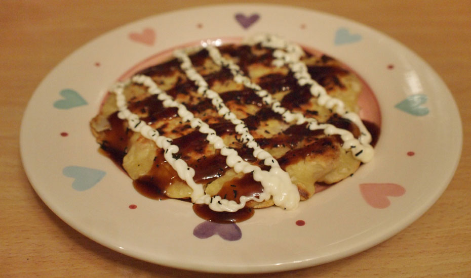 Step 7: Transfer to a plate, top with Okonomiyaki sauce, mayonnaise and seaweed sprinkles