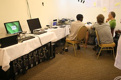 Room with desks around the edge, covered in computers and equipment
