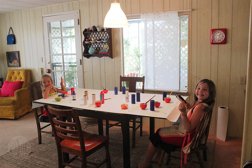 girls making patriotic craft at dining room table