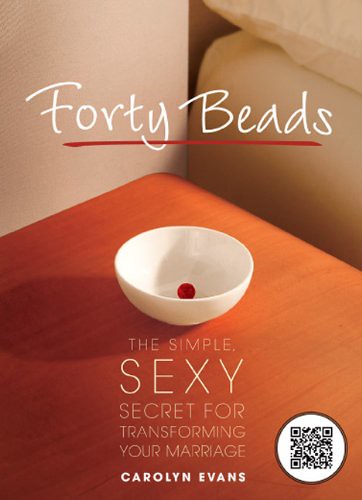 Forty Beads book cover, a photograph of the top of a wooden desk next to the edge of a white bed. The surface is empty except for a little white bowl with a red bead in it. The top of the cover reads "Forty Beads" in white; below the bowl is the subtitle "The Simple, Sexy Secret for Transforming Your Marriage" and the author's name, Carolyn Evans, also in white.