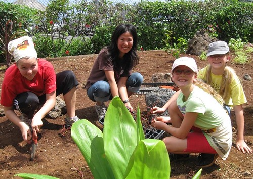 Katie Hamilton, Rie Kaku, Eliza Harris and Maya Hoeft take part in planting a coastal garden that will augment the diet of rescued endangered sea turtles at Hawaii's Sea Life Park's Rescue Program. The new garden, situated between the mountains and the sea -- or mauka to makai -- also serves as a living classroom where students see the connection between healthy forests and clean water.