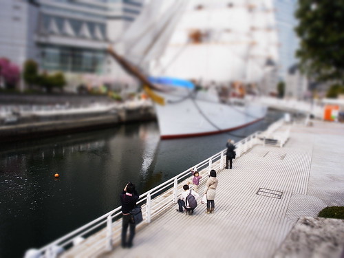 miniature looking at sailing boat