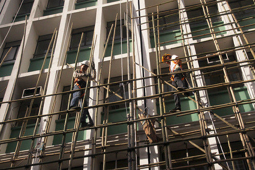 Workmen erect bamboo scaffolding in Hong Kong