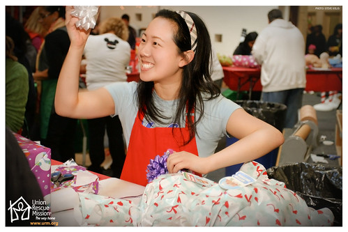Volunteer wrapping gifts at Christmas Store 2010