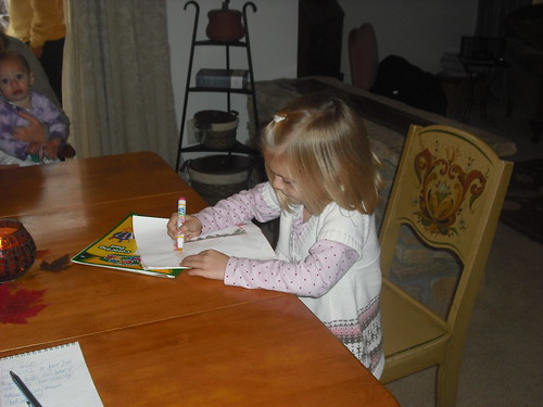 Five year old Hannah Yorgey draws at the table.