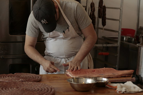 Rob Levitt removes the skin from a pork belly